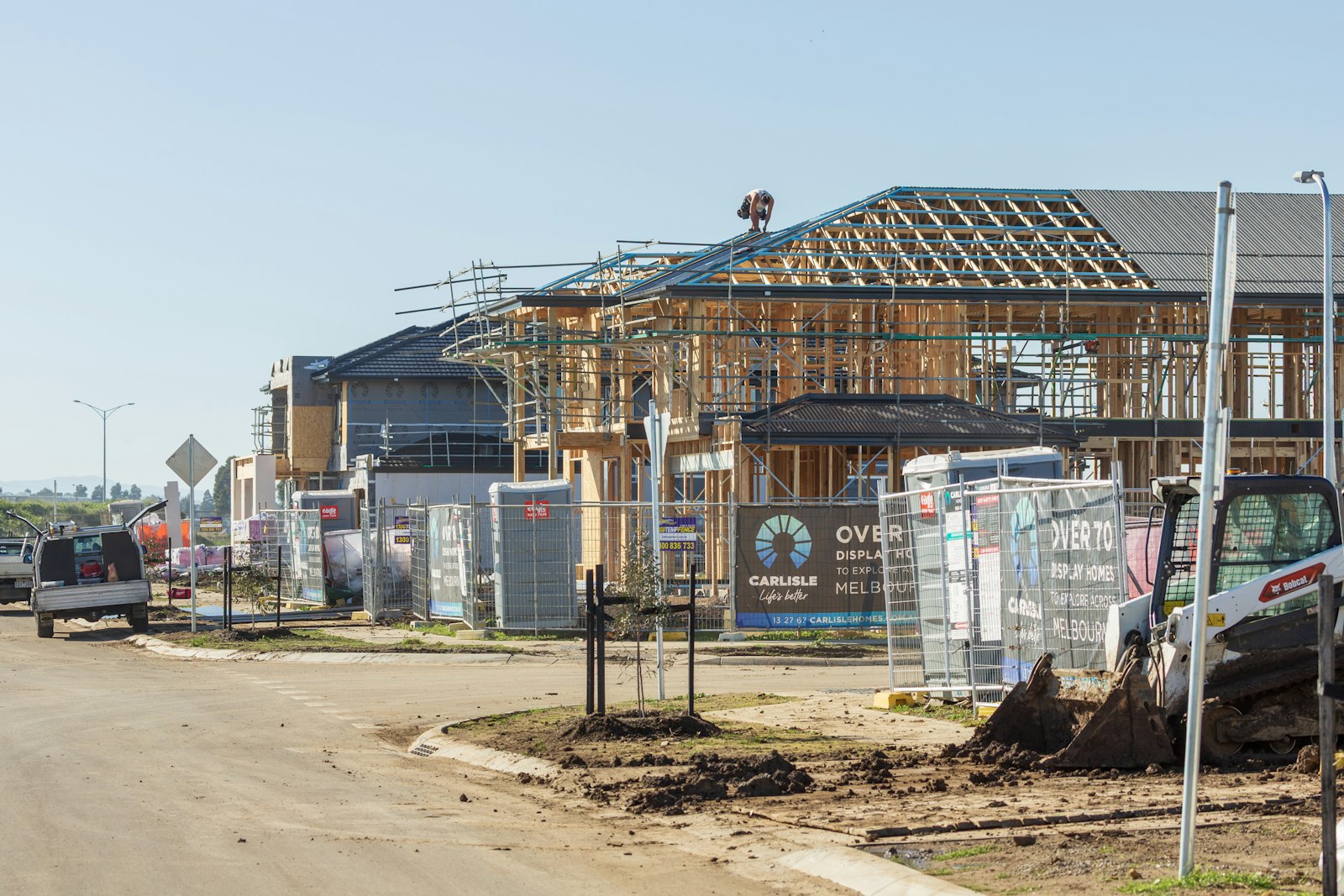 New houses under construction with wooden frames and scaffolding