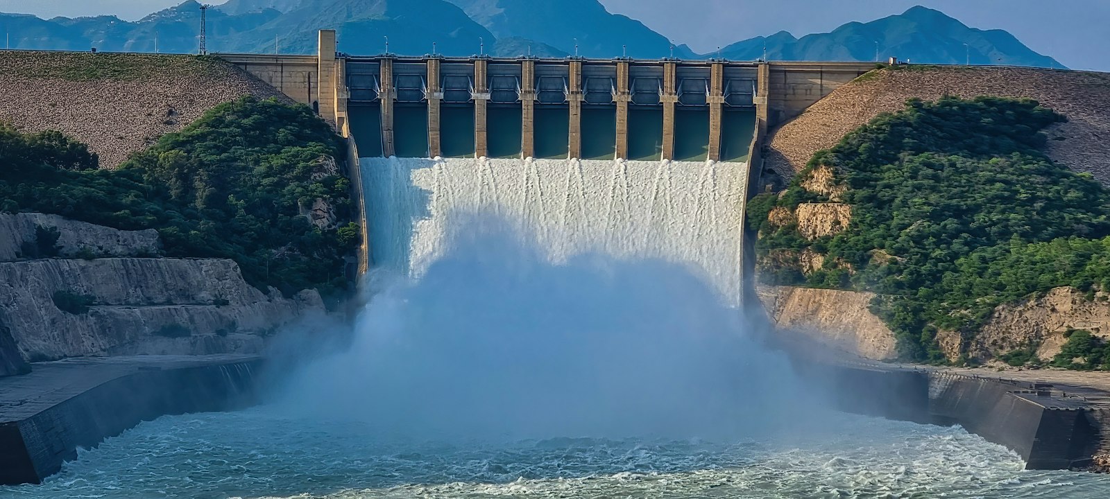 a large dam releasing water from a reservoir